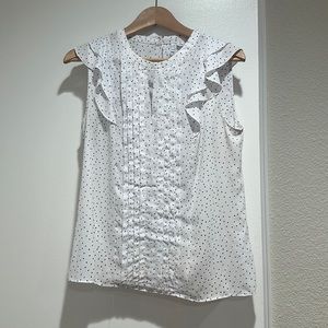 White blouse with black polka dots.